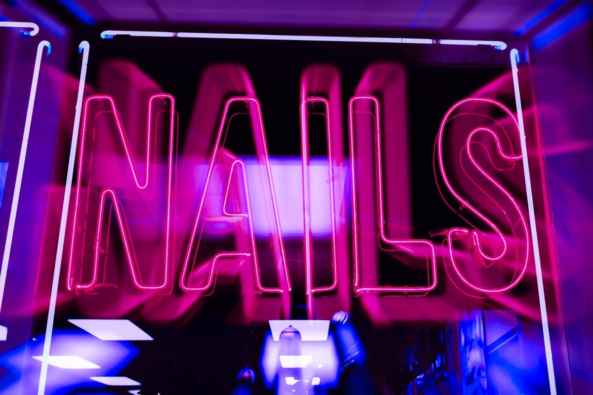 Pink neon script lettering typical of custom storefront signage