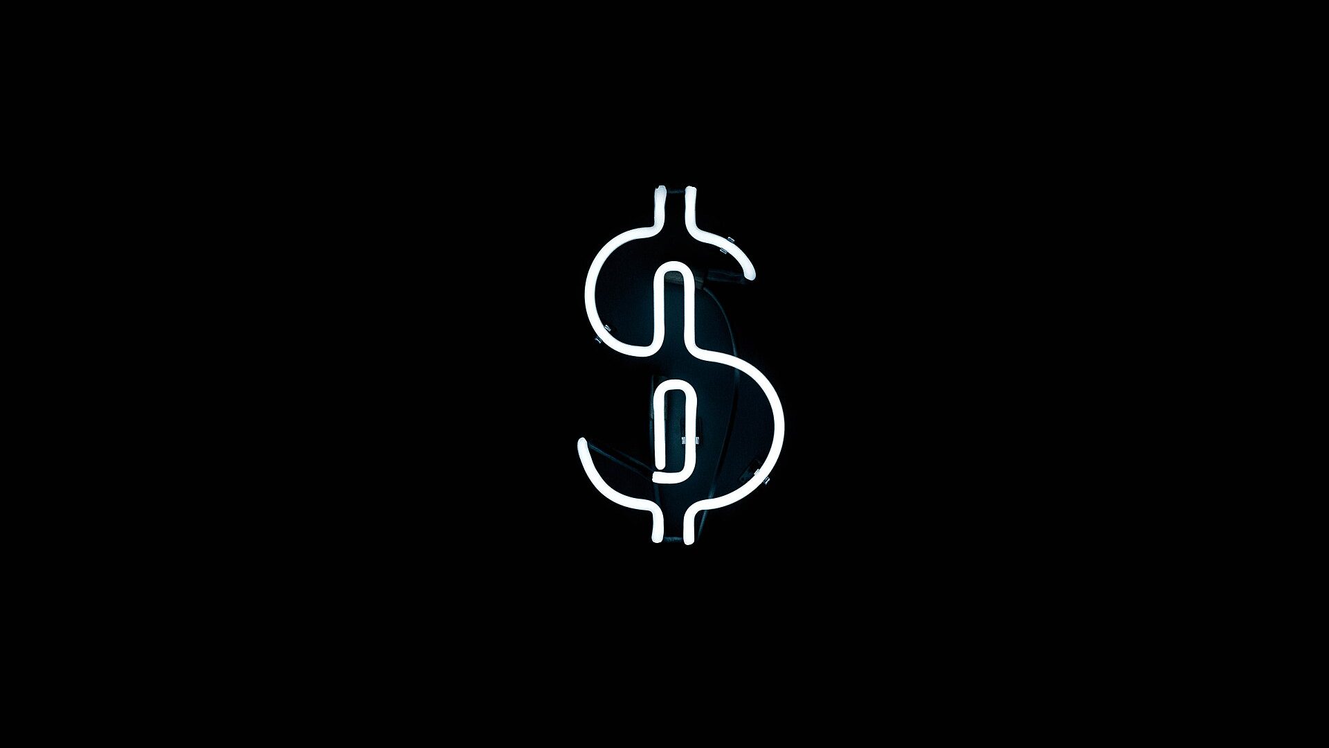 A single freestanding white neon sculptural symbol glowing against a black background