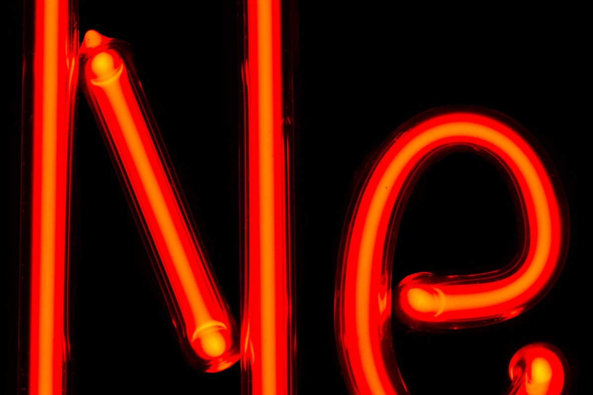 Close-up detail of hand-bent red-orange neon glass tubing