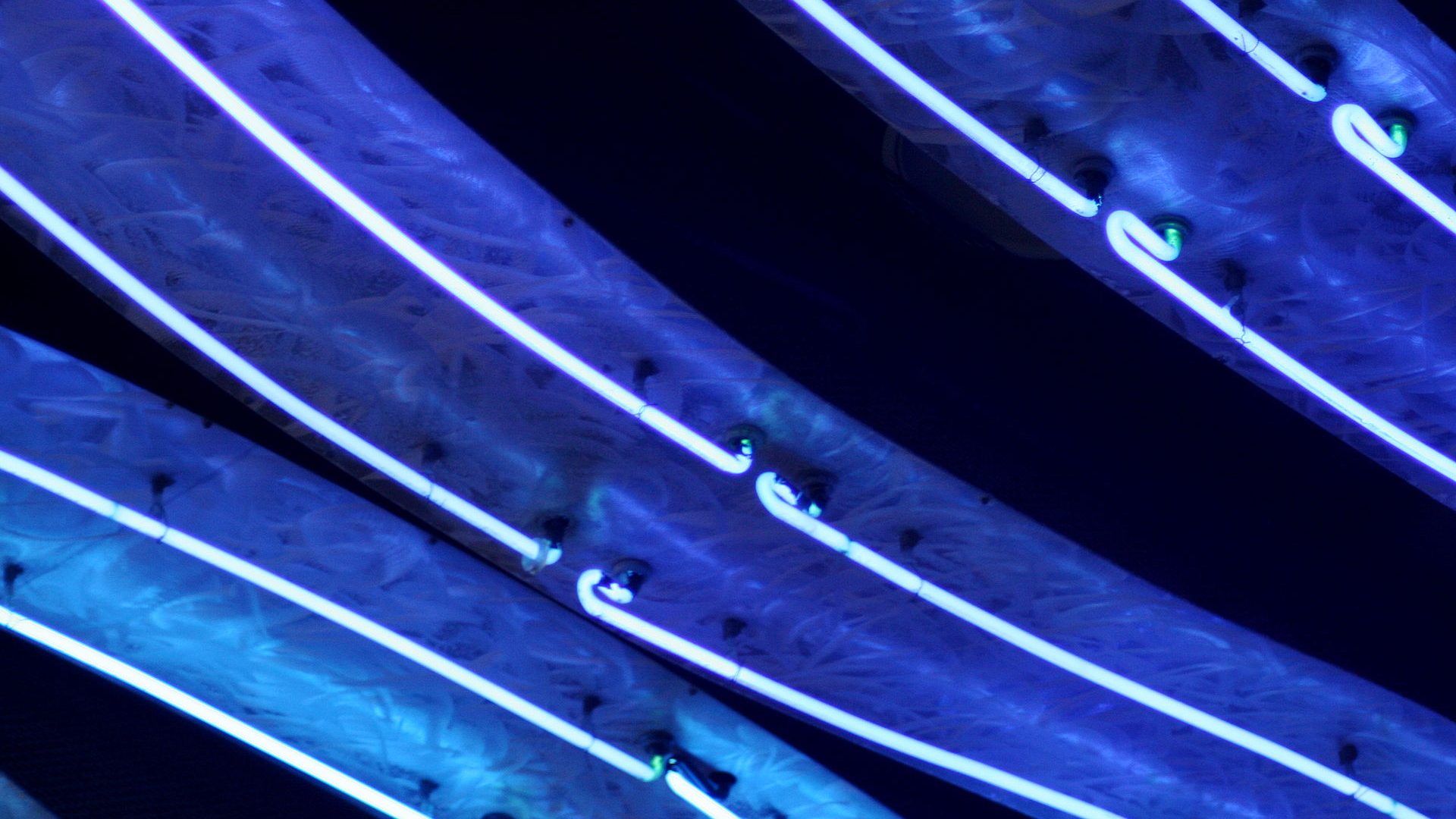 Cool blue architectural neon accent glow along a structural cove edge